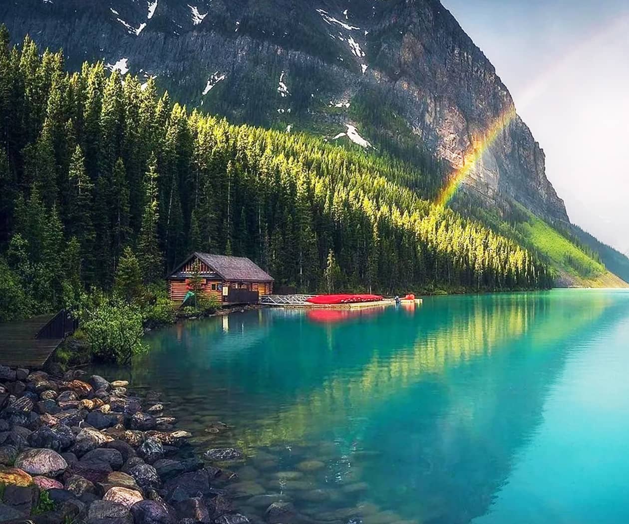 Rainbow Shines over Lake at Cabin Near Mountain Rainbow Shines over Lake at Cabin Near Mountain